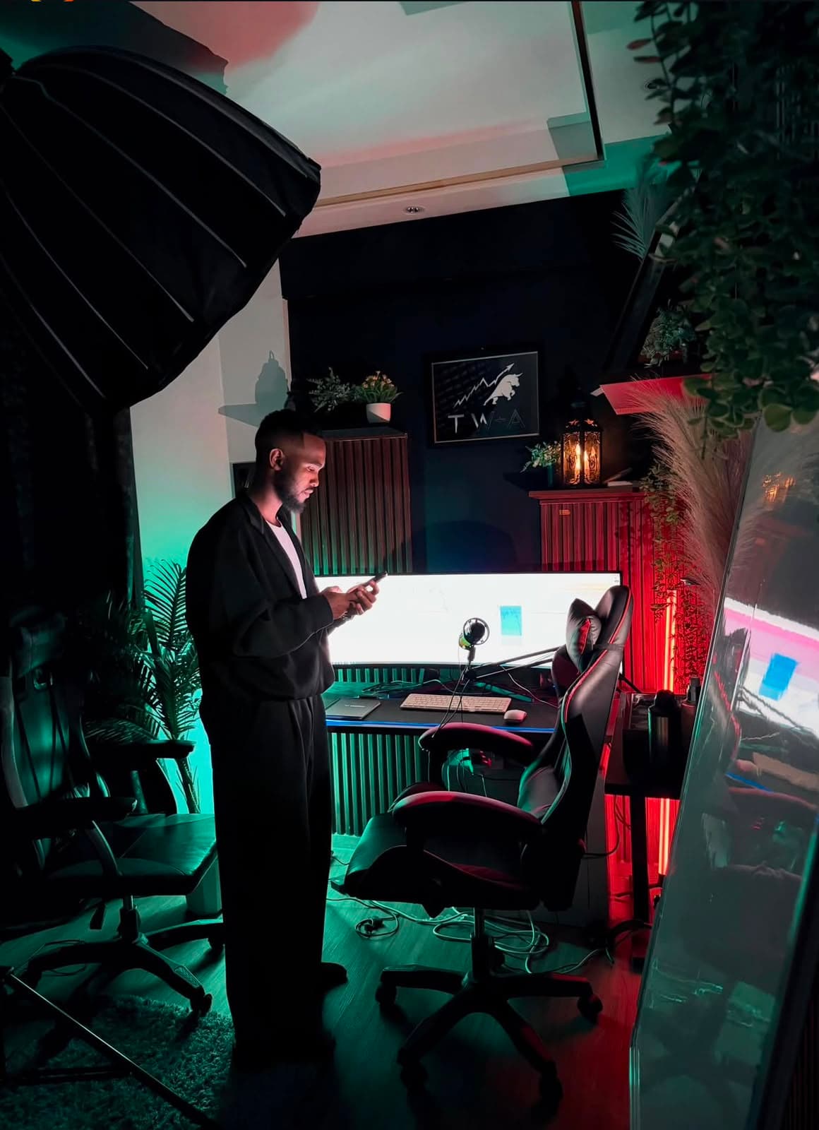 Ahmed at his home trading desk, charts on screen